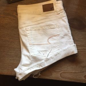 White distressed AE shorts